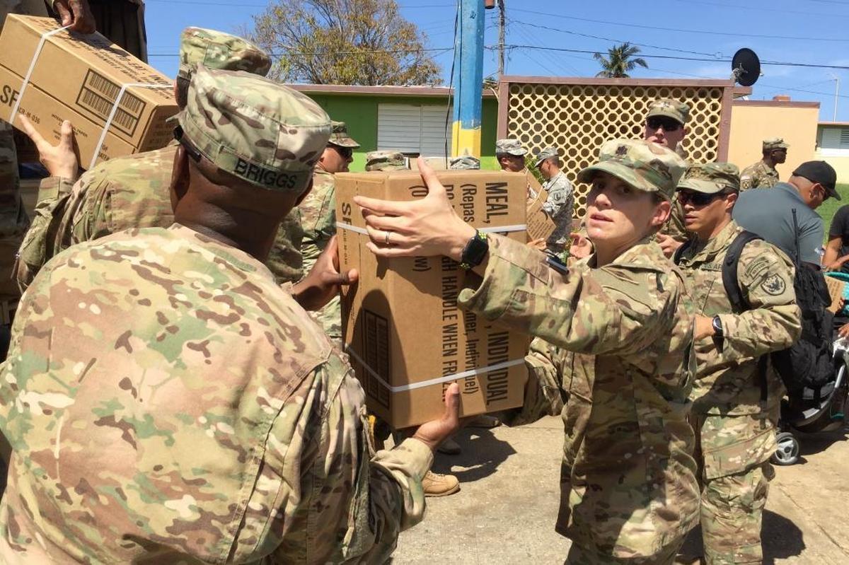 Soldiers deliver emergency food rations in the city of Aguadilla, Puerto Rico, on Sunday, Oct. 8, 2017.