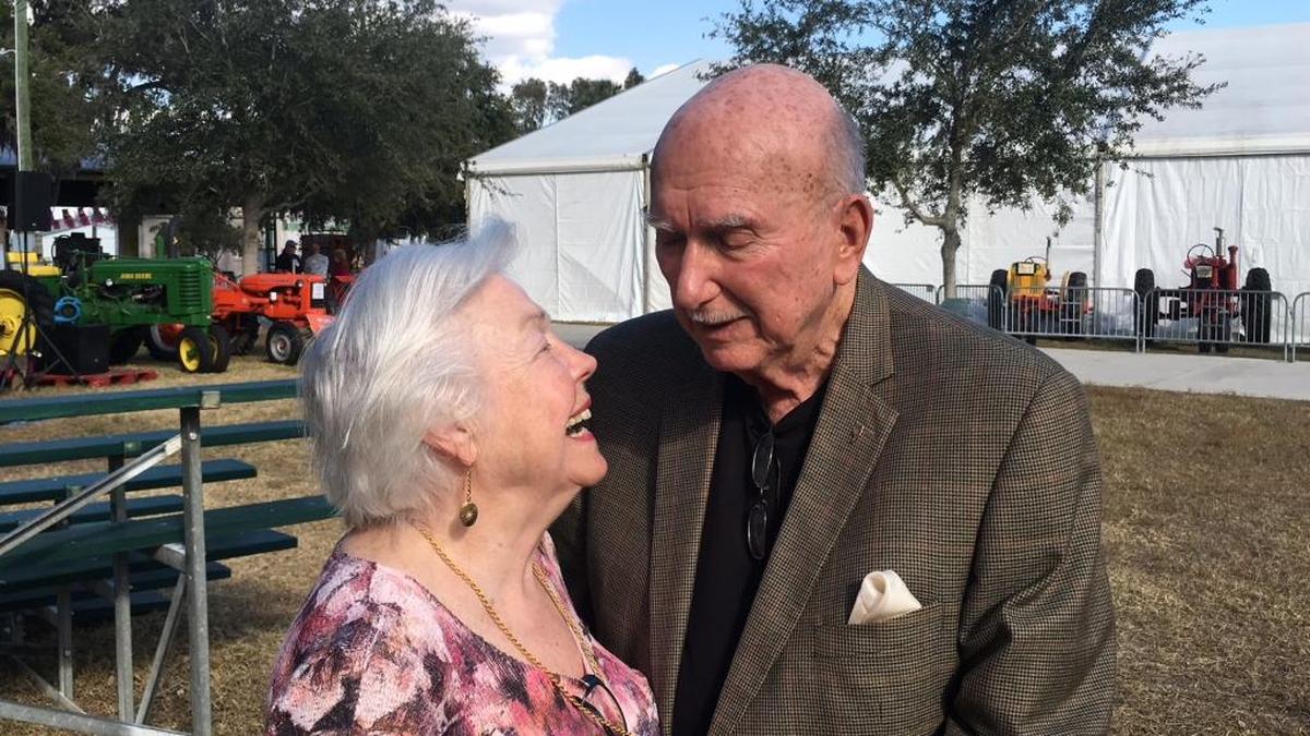 Edie Bustle, left, smiles up at her husband, Larry, who was honored on the last day of the 2018 Manatee County Fair Sunday when his shoe prints were cast in concrete. Bustle, a former Manatee County commissioner who was named the 2018 Distinguished Citizen Award winner last week, will soon join Manatee County Fair Distinguished Citizen Award winners from previous years whose shoe prints are on display at the historic Manatee County courthouse.