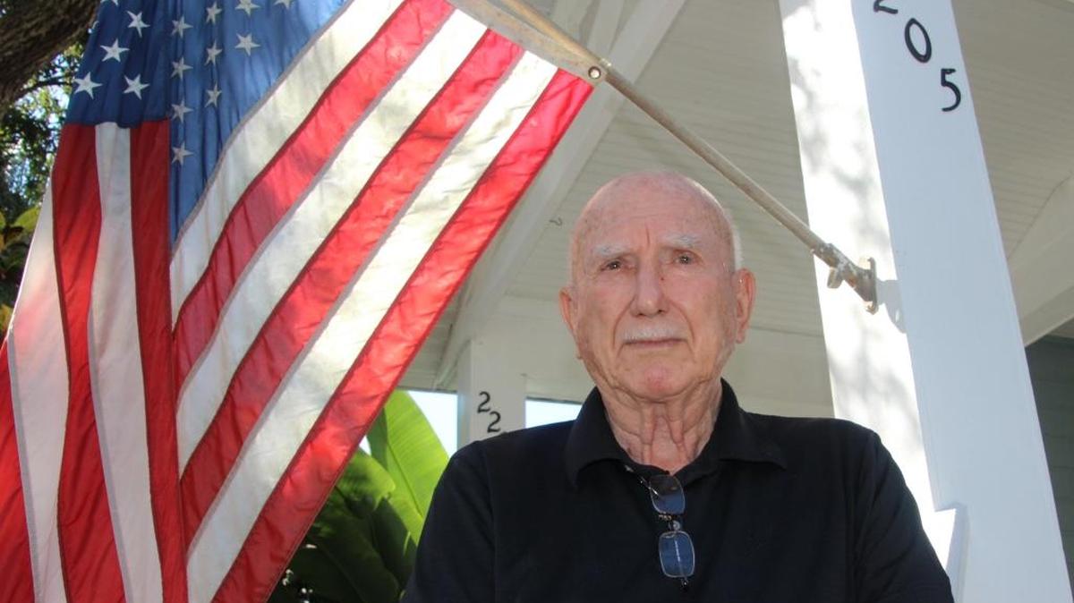 Retired Col. Larry Bustle stands on the front porch of his Palmetto home. He was shot down over North Vietnam.