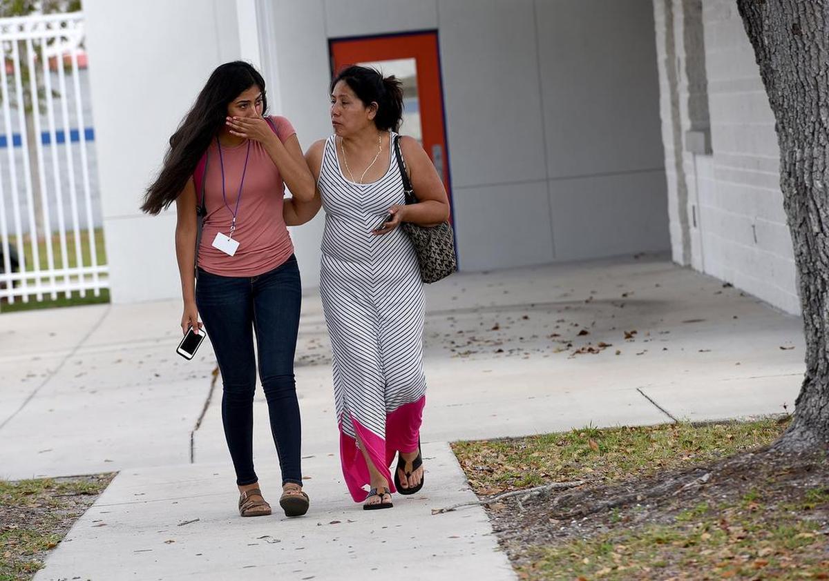 A threat written on the wall of a girls restroom at Southeast High led to a lockdown for hours, keeping students in their classrooms and worried parents outside the school. Anelis Gonzalez leaves the school with her mother, Noemi, after the lockdown was lifted.