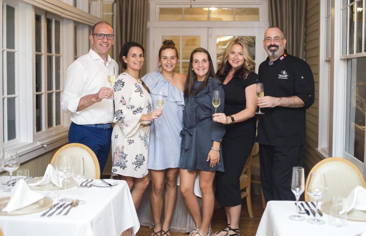 Wim Lippens, Mieke Lippens, Maxence Lippens, Manon Lippens, Jenn Sayko and Chef Stephen Cotett pose for a portrait in the new dining room at the Palmetto Riverside Bed and Breakfast.