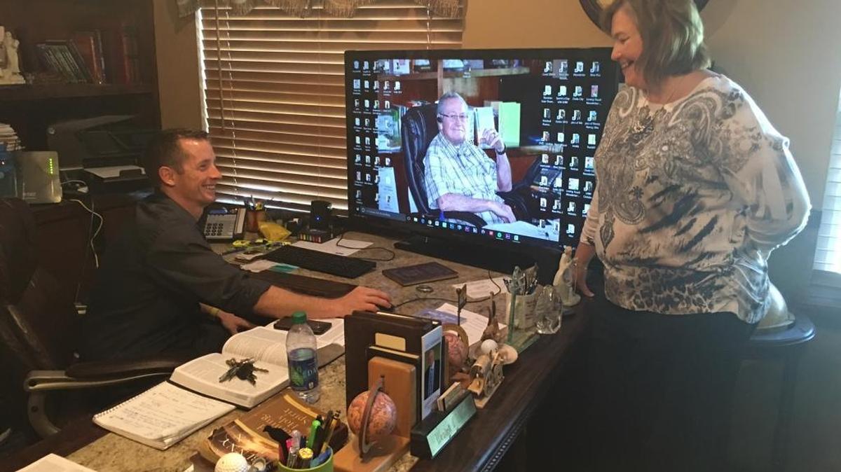 With a gigantic computer screen wallpaper of the the late Rev. Wendell Wilson to inspire them, Loving Hands Ministries’ new executive director Joseph Hamblin, left and Kimberly Wilson-Dodson, Wendell Wilson’s daughter and the president of Loving Hands Ministries, work in his old office last week. Hamblen and Wilson-Dodson are continuing the work that Wendell Wilson did for decades in Manatee County.
