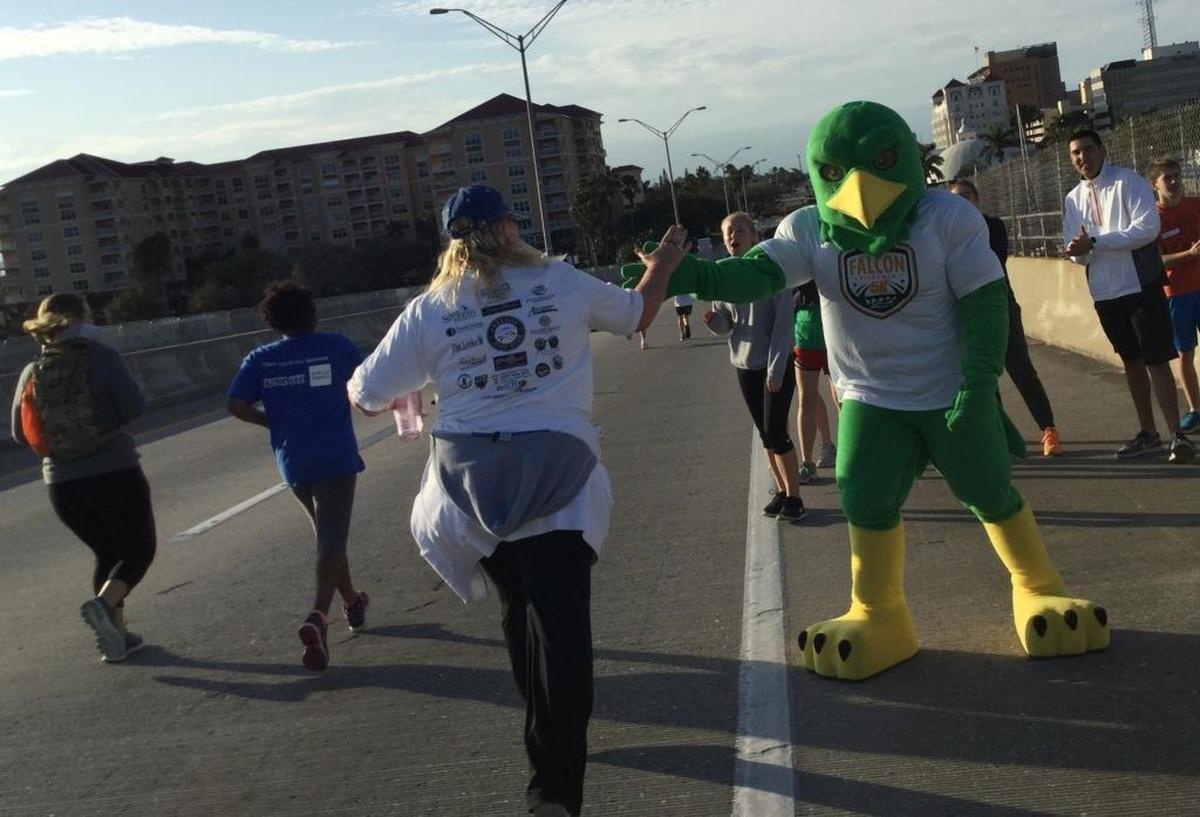 Freddy the Falcon and students from Saint Stephen’s Episcopal School cheer on runners atop the Green Bridge Saturday morning as part of the Saint Stephen’s 5K run that kicks off the annual Bradenton Area River Regatta.