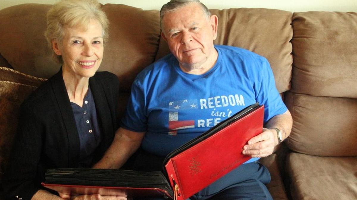 Joan and retired Col. Terry McDonald look through his photos of the Vietnam War at their Ellenton home. They have been married for 54 years.