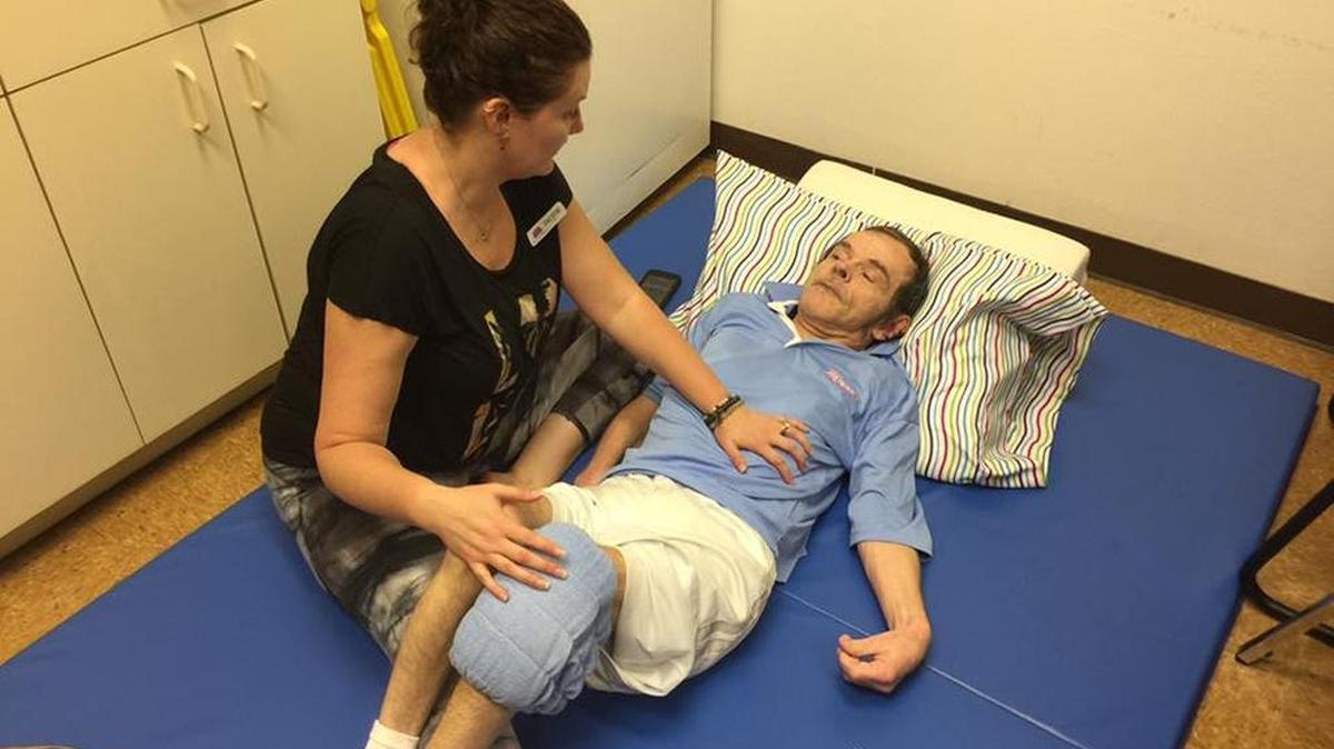 Cheryl Albright, left, an occupational therapist and owner of the new Bradenton-based Soul to Soul Yoga, LLC, works with a 56-year-old patient named Jeff at a United Celebral Palsy group home in Palmetto recently. Albright believes people with disabilities of all kinds can benefit from the mind-focusing, peace and relaxation that yoga can bring.