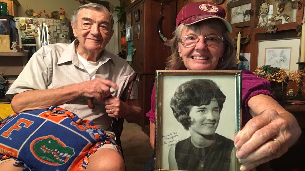 Ellenton’s Dot Garland holds up a picture of her “golden” friend, Mary Alice Swope. At left is Garland’s husband, Bill. As to the artifacts they are surrounded by, the Garlands are a “divided” house, with Bill a Florida Gator and Dot a Florida State Seminole.