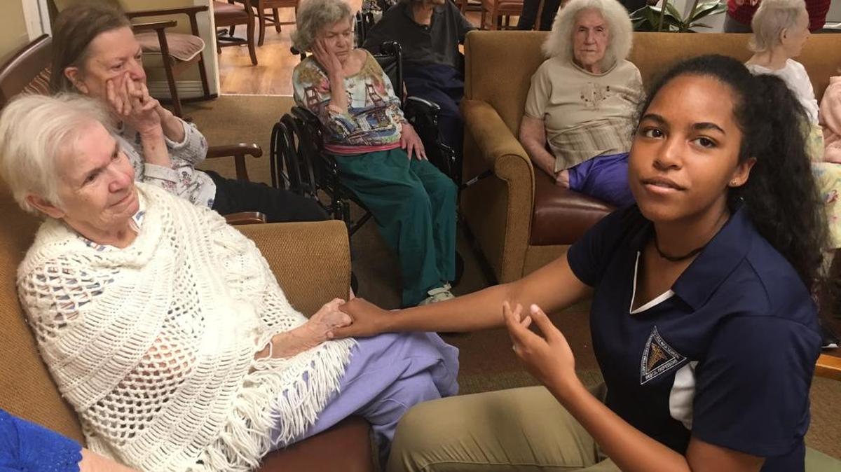 Lilly Walker, 14, right, holds hands with patient Barbara Licht in the memory care wing of Brookdale Bradenton Gardens last Wednesday. Lilly spent her summer volunteering at Brookdale, an assisted living and memory care facility.