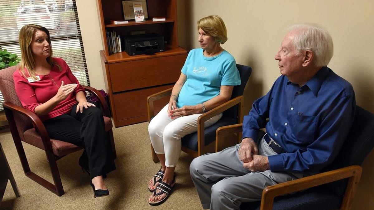 Care advisor Jennifer Williams speaks with Carol and Don Williams, Carol is challenged with Parkinson's. Neuro Challenge Foundation for Parkinson's opened a new office in Bradenton due to growing client numbers.