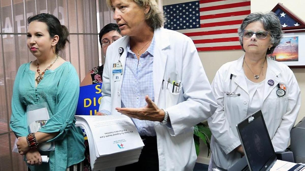 In this 2015 photo, Martha Baker, a registered nurse at Jackson Health System, is pictured in 2015 campaigning for Florida to expand Medicaid eligibility to cover nearly all low-income adults — a provision of the Affordable Care Act. Florida has refused to expand Medicaid eligibility under the health law. However, an estimated 1.6 million Floridians have signed up for coverage on the ACA insurance exchange at healthcare.gov.