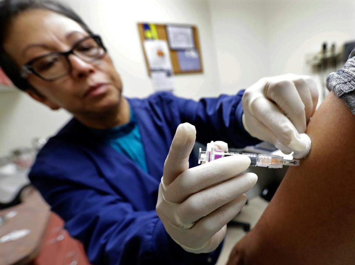 Don’t be a baby. A flu shot doesn’t hurt that bad and it won’t give you the flu. But it might prevent, or lessen the severity, of one. This Jan. 11, 2018 file photo shows Ana Martinez, a medical assistant at the Sea Mar Community Health Center, giving a patient a flu shot in Seattle.