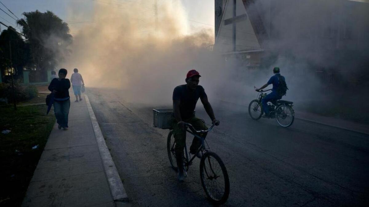 In this March 2016 photo, people make their way through fumigation fog sprayed to kill Aedes aegypti mosquitoes in Pinar del Rio, Cuba. Florida health officials said the state’s first sexually transmitted Zika case of 2017 occurred after the infected person’s partner returned from a visit to Cuba.