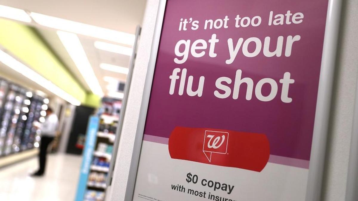 A sign advertising flu shots is displayed at a Walgreens phramacy on Jan. 22, 2018, in San Francisco, California. A strong strain of H3N2 influenza has claimed the lives of 74 Californians under the age of 65 since the flu season began in October of last year. People are being encouraged to get flu shots even through the vaccine has been only percent effective in combating the influenza.