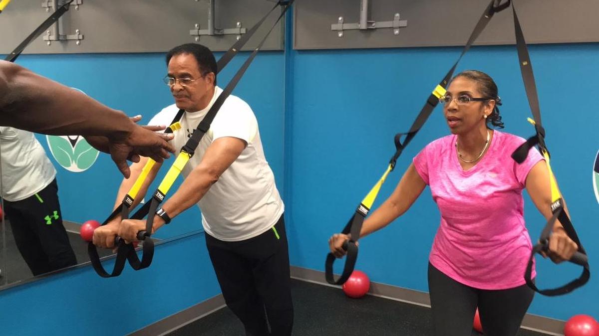 Dr. Inda Mowett, right, and her colleague, Walter “Mickey” Presha of MCR Health Services, center, work out at Mowett’s new fitness studio called The Aesthetic and Wellness Center, 5219 State Road 64 E., Bradenton, last week. At far left, directing them with his hands, is fitness director Michael Fulton.