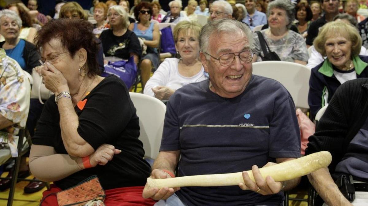Senior citizens check out a walrus penis bone during a Zoo Miami animal-sex talk.