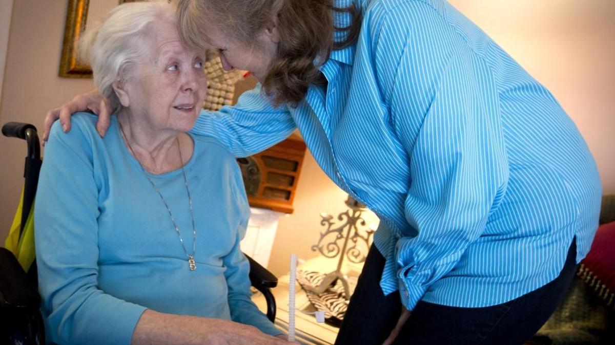 Barrie Page Hill, right, shares a moment with her mother Bobbie Wilburn, 79, in Arlington, Texas. Wilburn, who developed Alzheimer’s disease, moved in with Hill.