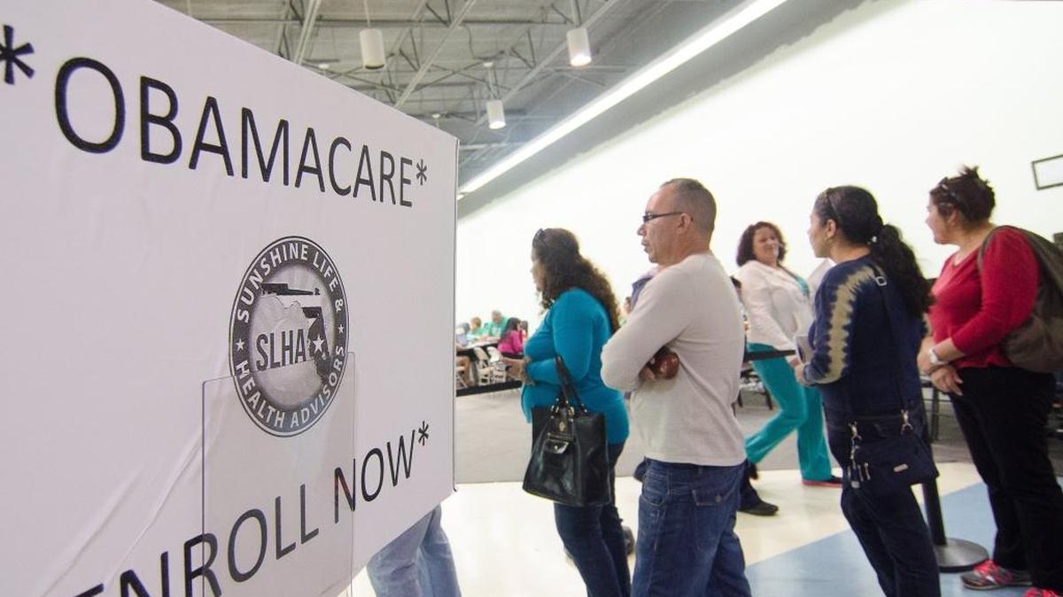In this December 2014 photo, applicants form a line outside a storefront insurance broker at the Mall of the Americas in Miami. This week, Florida’s insurance regulator asked insurers selling 2018 Affordable Care Act plans to submit a second set of rates for next year that account for the potential loss of cost-sharing subsidies, which help eligible low-income Americans pay their out-of-pocket costs, such as deductibles and co-payments.