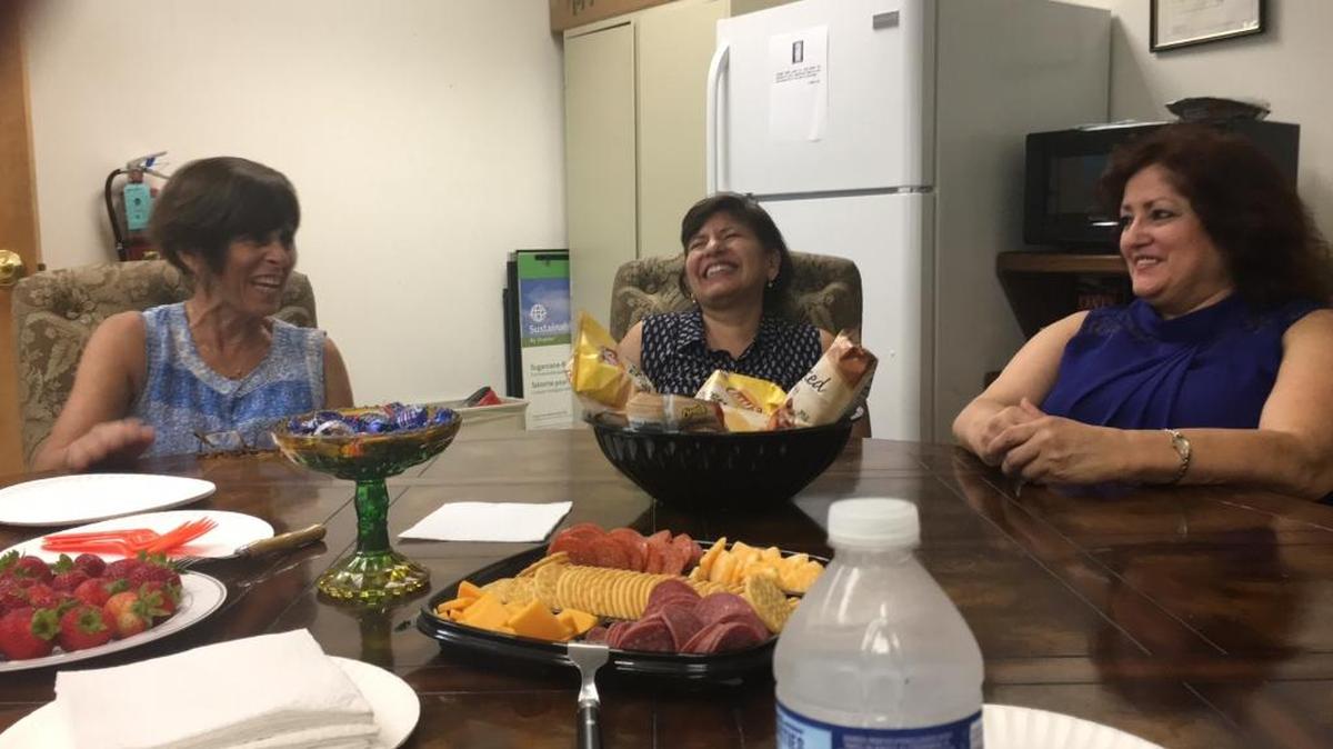 From left, Margaret Sciscento, Blanca Gentile and Lucy C. Sanchez Cruz, all employees of the Catholic Charities Diocese of Venice office at 1219 16th St. W., Bradenton, enjoy a laugh during a visit from Catholic Charities' chief executive officer Peter Routis-Arroyo last week.