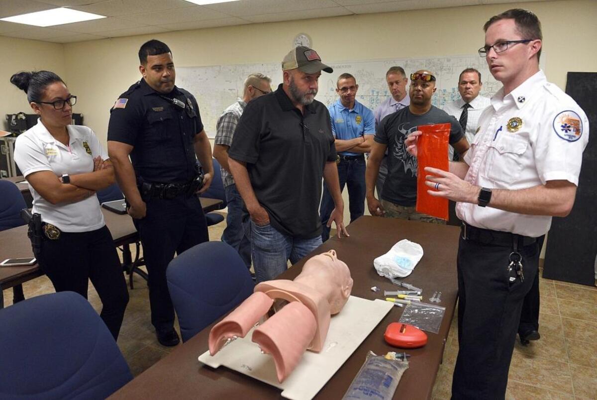 Sean Dwyer, right, district chief of EMS, discusses various components of a Narcan kit to Bradenton police officers during recent training to administer Narcan to opioid overdose victims.