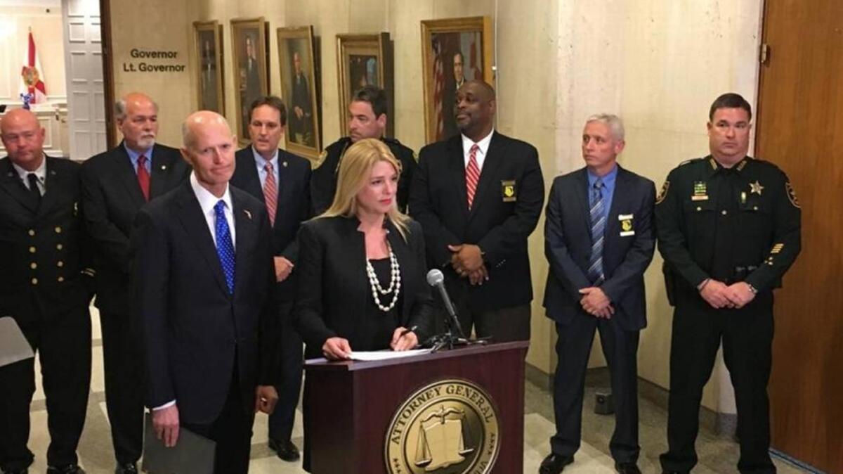 Florida Gov. Rick Scott and Attorney General Pam Bondi announce a statewide tour of workshops over the opioid epidemic in the state Capitol.