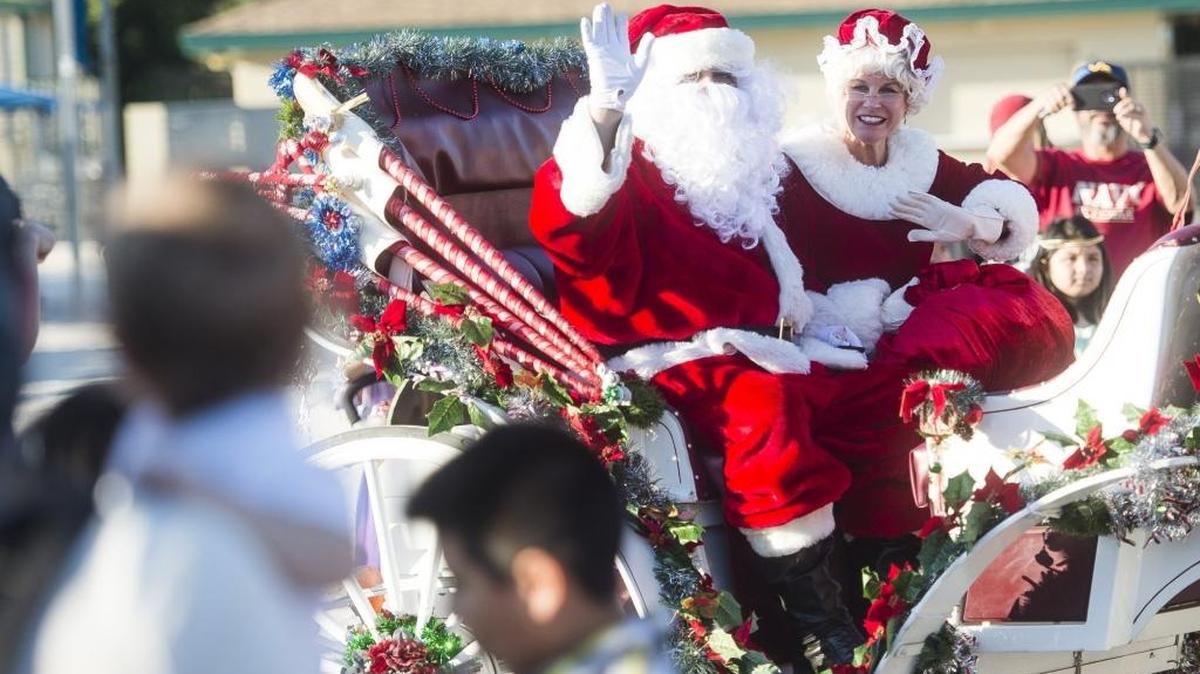 Santa and Mrs. Claus wave to a crowd of excited children as they arrive on their sleigh to the “A Night Before Christmas” celebration on Saturday evening at G.T. Bray Park in Bradenton.