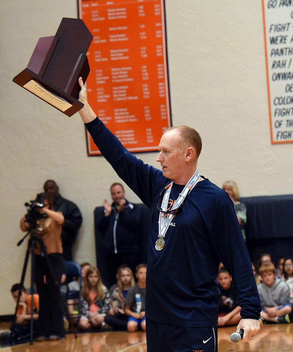 Bradenton Christian’s basketball coach Scott Townsend holds up their trophy during a welcome back pep rally for the basketball team after bringing home the runner-up title to the state championships. TIFFANY TOMPKINS/Bradenton Herald