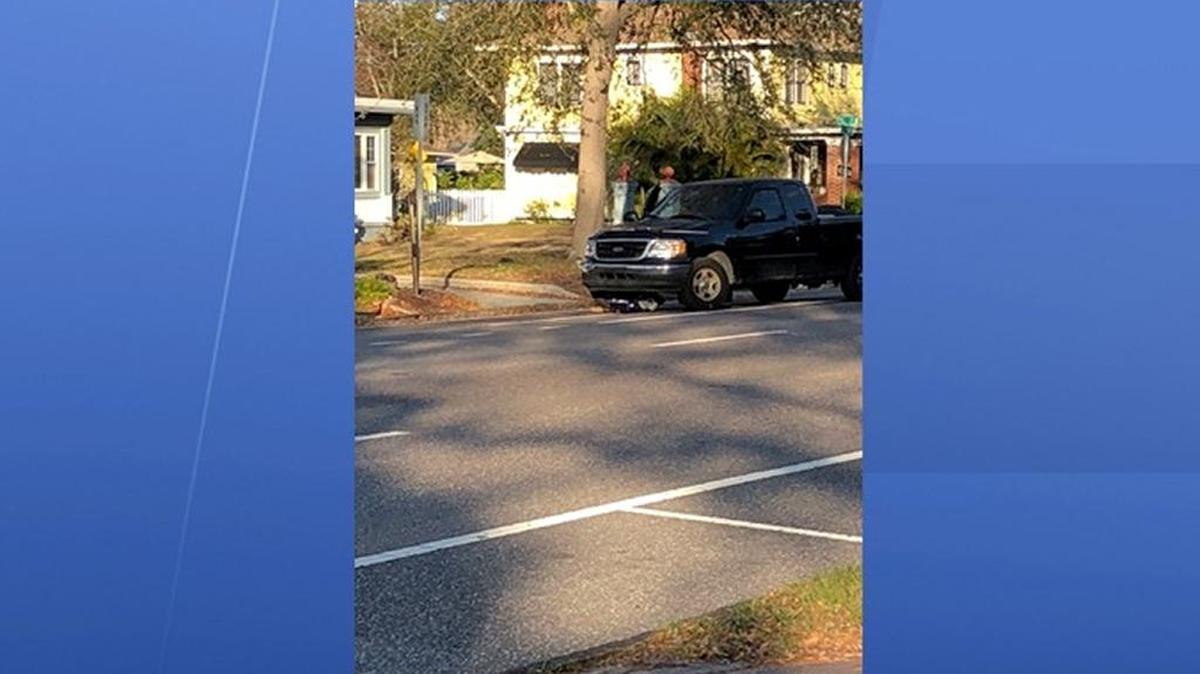 A wheelchair is visible under a truck at the scene of a crash involving a pickup and a man in a wheelchair in St. Petersburg on Friday.