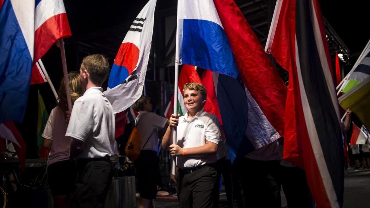 Rowers from the Sarasota Scullers Youth Rowing program hold flags representing each of the competing 69 countries as rowing enthusiasts from all around the world gather for the World Rowing Championships opening ceremony on Saturday evening at Nathan Benderson Park in Sarasota.