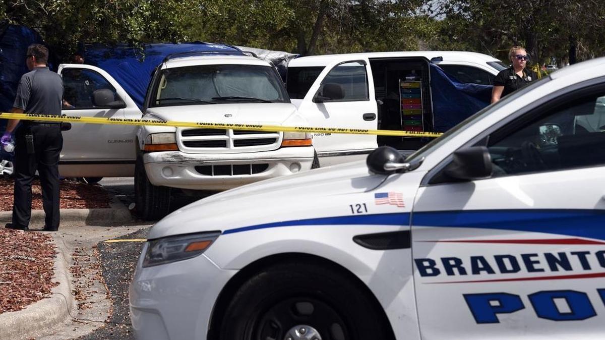 Bradenton Police investigate the scene in the parking lot at Walmart on Cortez Road where a dead body was discovered in a SUV.