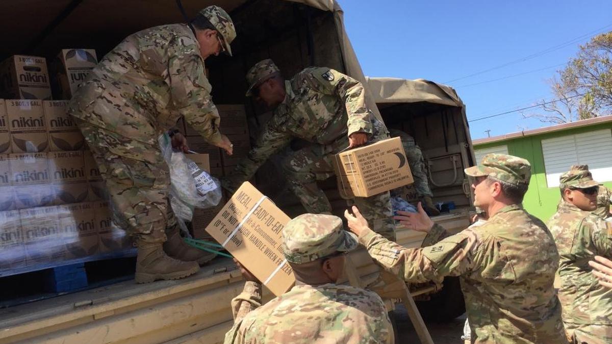 Soldiers deliver boxes of food and water to residents in Aguadilla, Puerto Rico, Sunday, Oct. 8, 2017. Aguadilla is in the northwest part of the hurricane-lashed island.