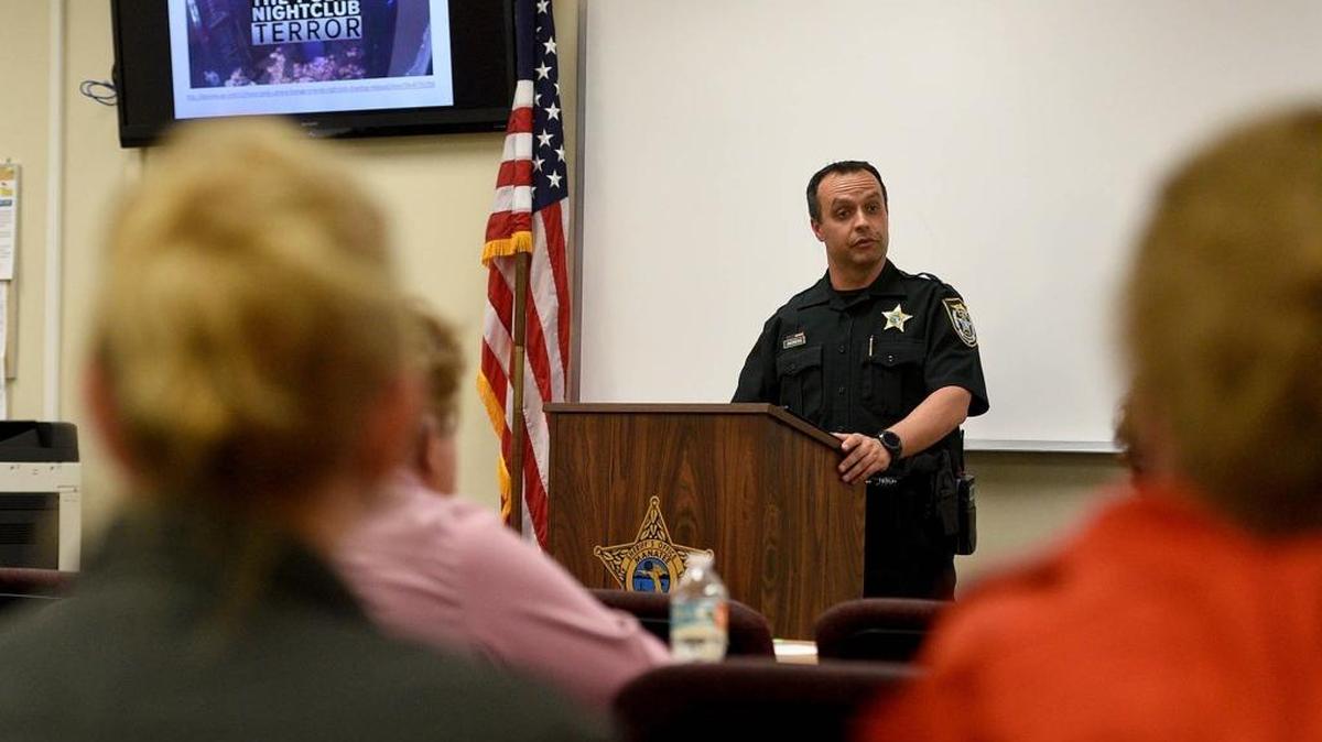 Lt. Robert Andrews of Manatee Sheriff's Crime Prevention unit teaches a group of civilians about how to respond in an active shooter situation Thursday.