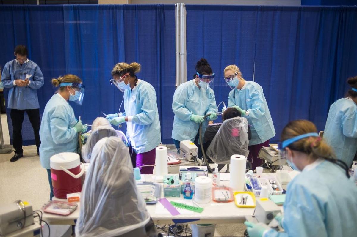 Dentists perform work on patients as Manatee Technical College hosts the Remote Area Medical free mobile clinic event at the MTC main campus in Bradenton.