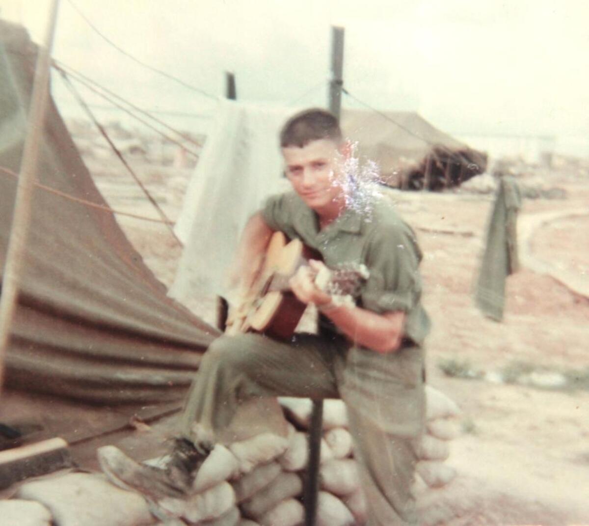 In a quieter moment in Vietnam, Robert Graves played his guitar.