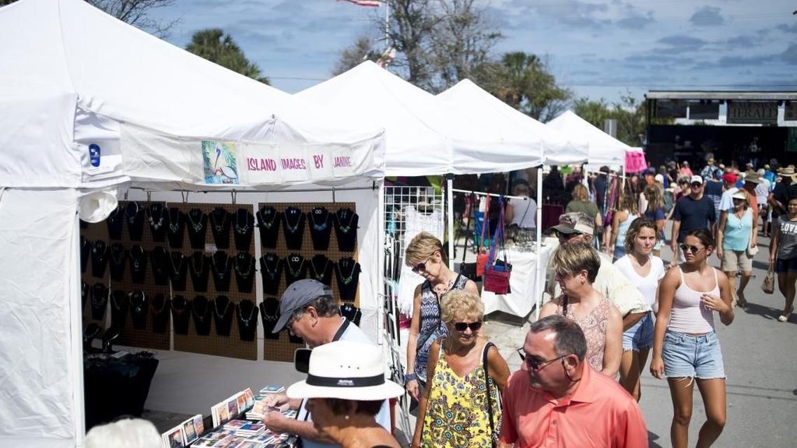 Locals browse vendors during Anna Maria Island's Bayfest on Saturday afternoon on Pine Avenue on Anna Maria Island.