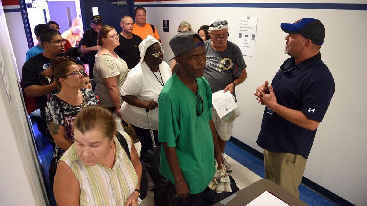 Evacuees wait to register for the shelter at Manatee High School Friday as Hurricane Irma approached.