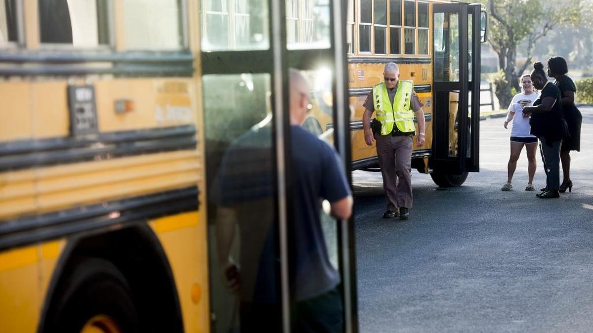 A Florida Highway Patrol trooper investigates the crash scene after a Louise R. Johnson Middle School bus was struck by a pickup on 63rd Avenue East on Thursday in Bradenton.