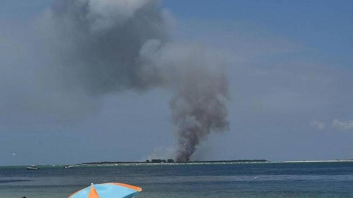 Firefighters battled a blaze sparked by a lightning strike July 26 that burned about 80 acres on Egmont Key.