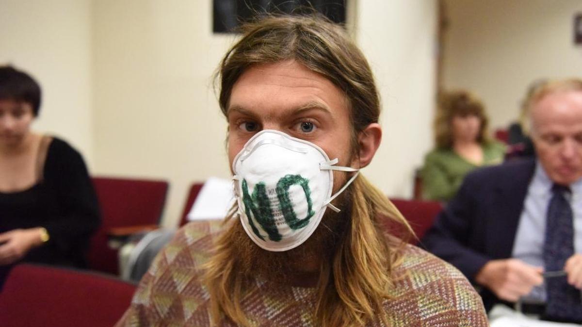 Daland Fithian wears a mask that reads "NO" while waiting for the start of the special land use meeting on Jan. 26. The Mosaic Company is presenting their proposal for rezoning 3,600 acres of their land to be able to mine on their Wingate East property.