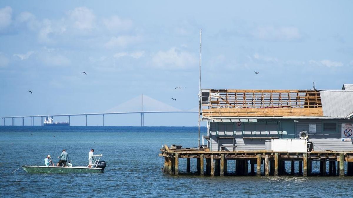Damage to the Anna Maria City pier is seen while fishermen angle in the surrounded waters as resident of Anna Maria Island recover from Hurricane Irma on Tuesday afternoon on Anna Maria Island.