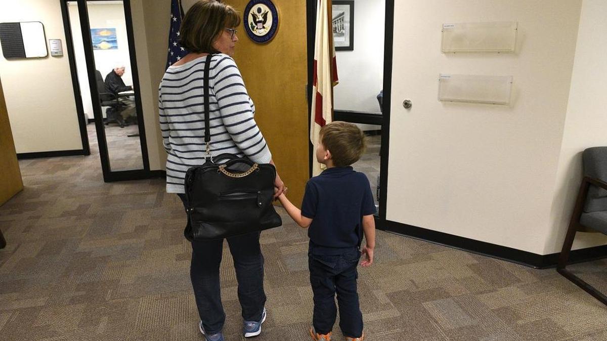 Kathy Flora and her grandson, Jackson, 4, wait outside Rep. Vern Buchanan’s office to let him know she is against President Donald Trump’s immigration ban.