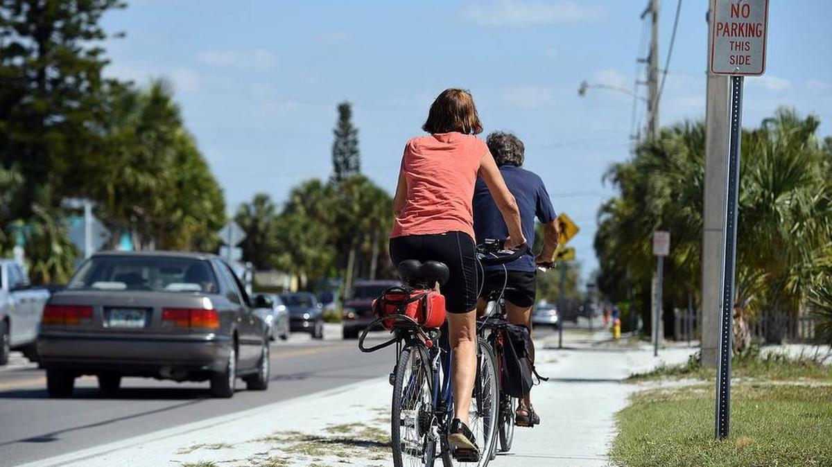 Cyclists ride on the sidewalk down Gulf Drive on the north end of Anna Maria Island.