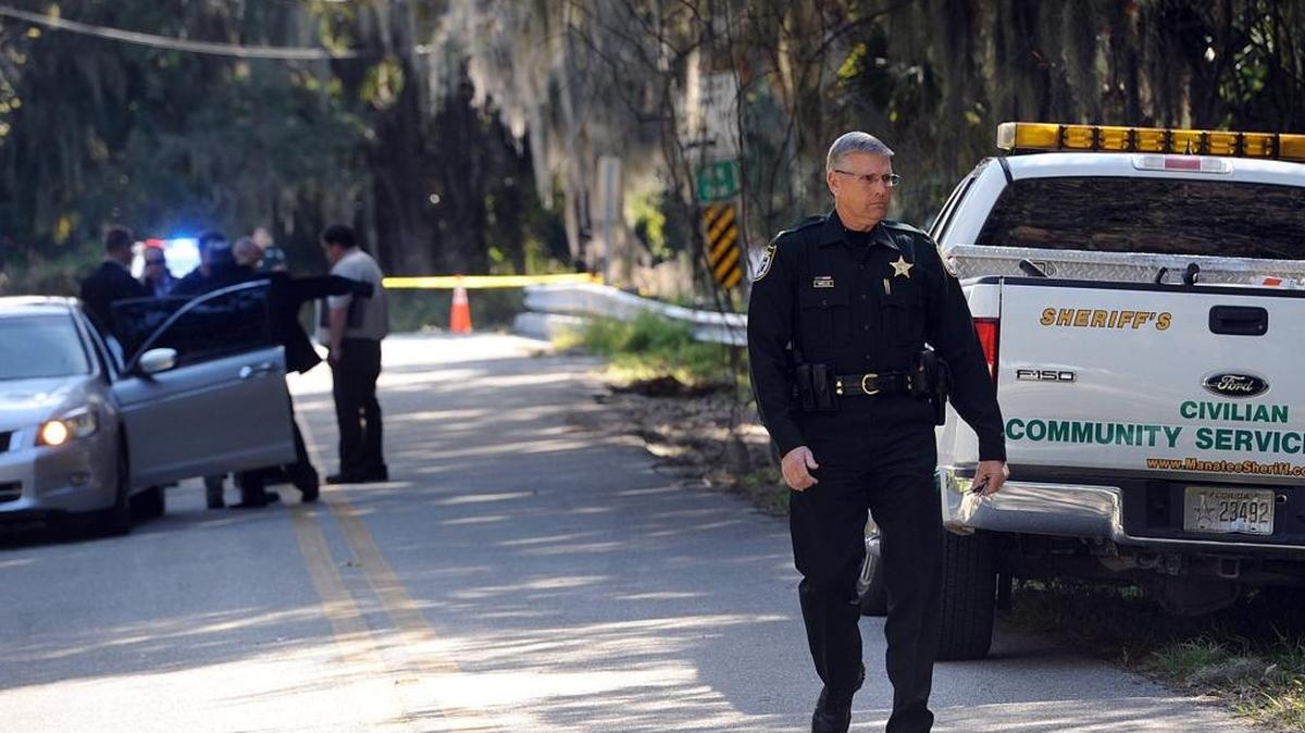 Law enforcement, including Manatee Sheriff's Col Rick Wells, investigates the scene where the body of a woman believed to be in her 20's was found on Bishop Harbor Road Tuesday afternoon. The death is being treated as a homicide, according to officials.