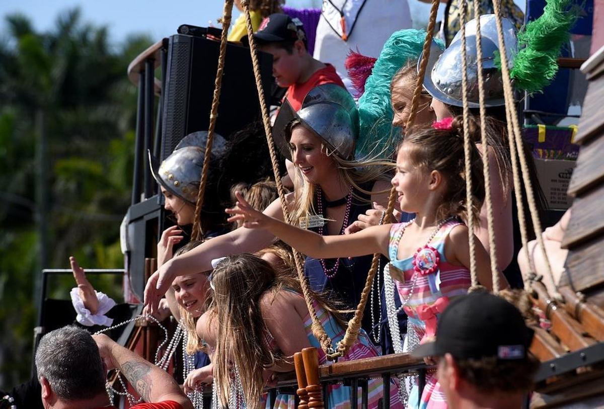 Members of the Queen's Court wave from their float during the Hernando DeSoto Historical Society's annual Children's Parade in Palmetto.