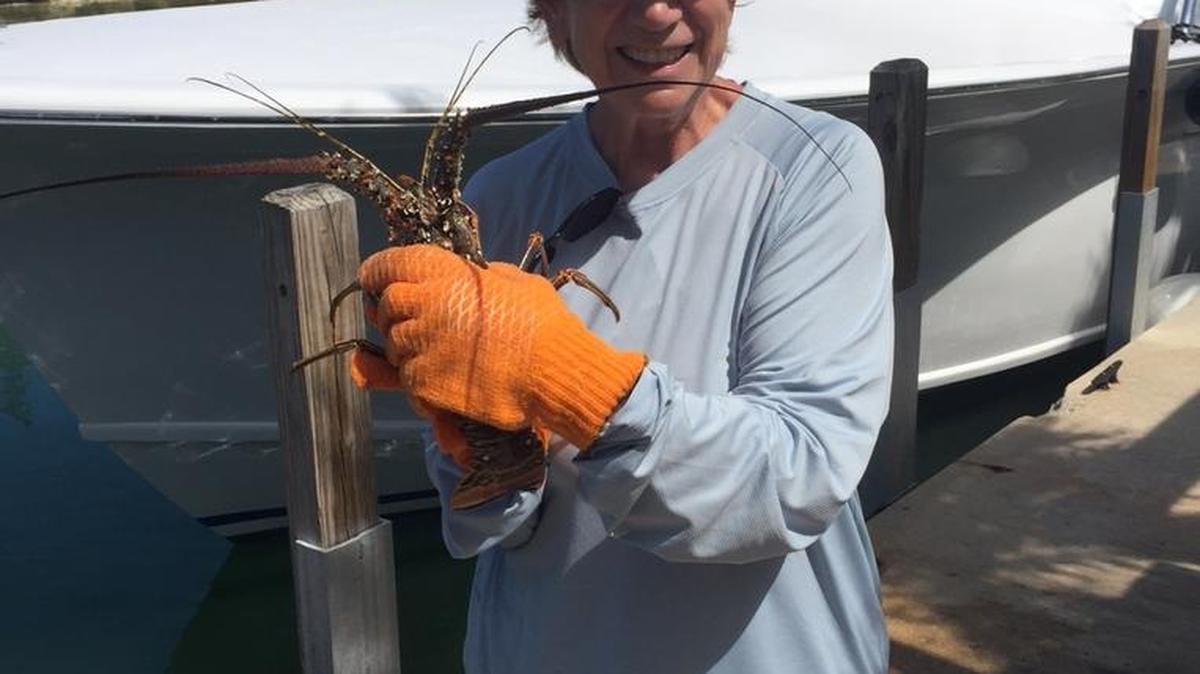 Rose Carlson catches a lobster in the Florida Keys.