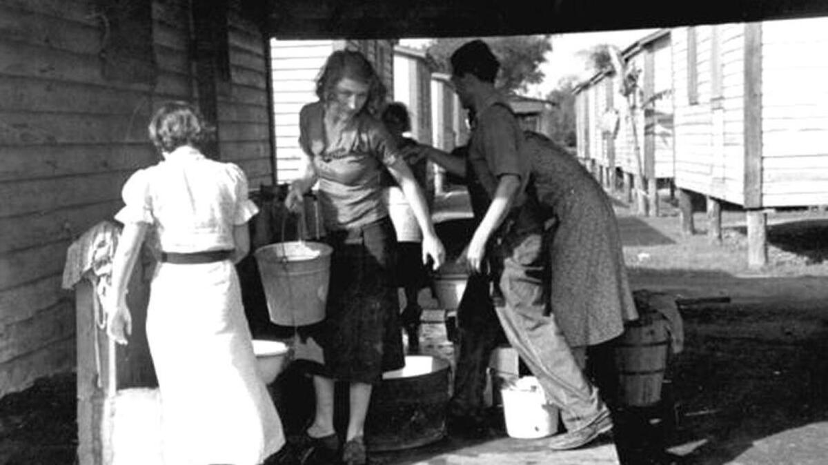 Families got water at migrant camps during the Great Depression.