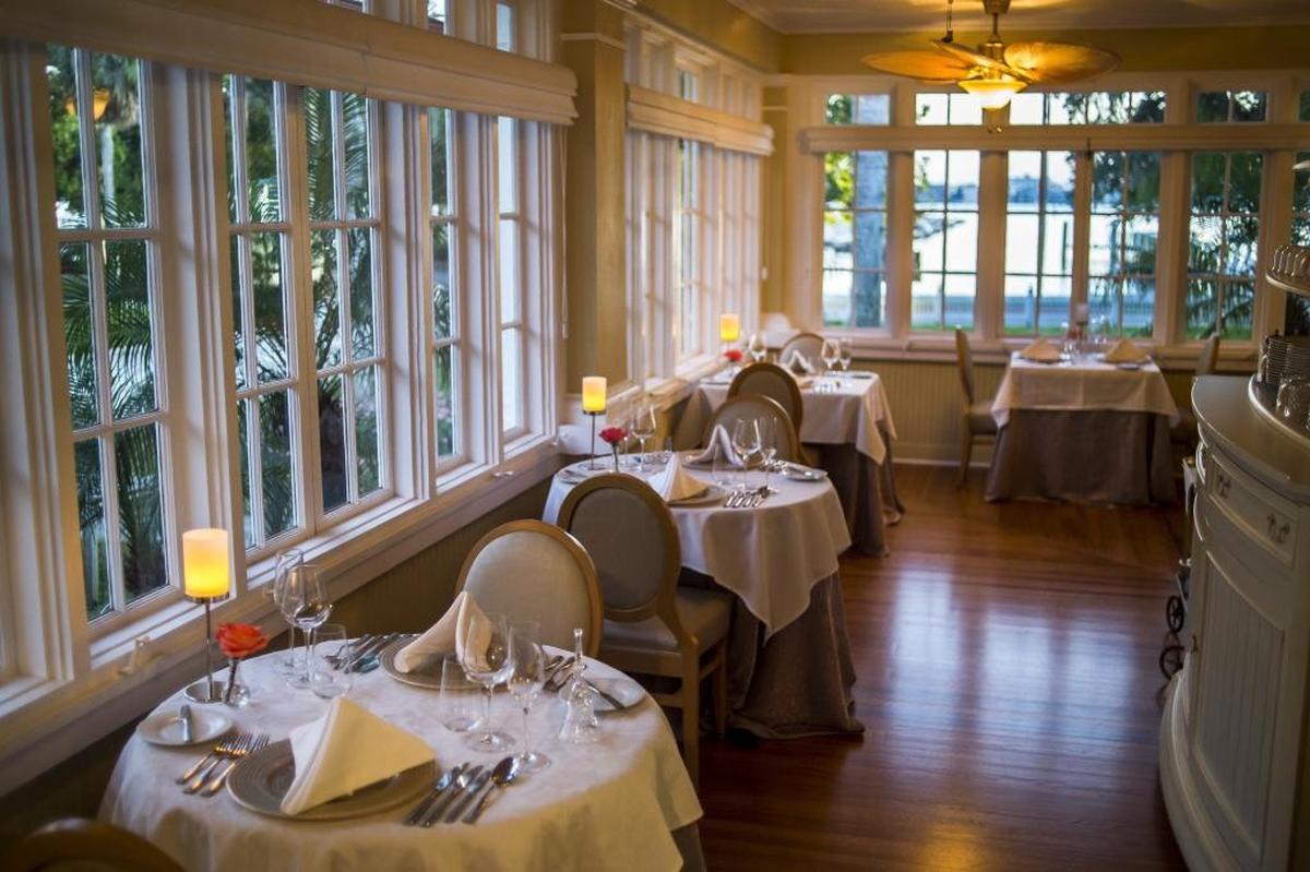 The new dining room at the Palmetto Riverside Bed and Breakfast is seen as the sunset colors the sky above the Manatee River.