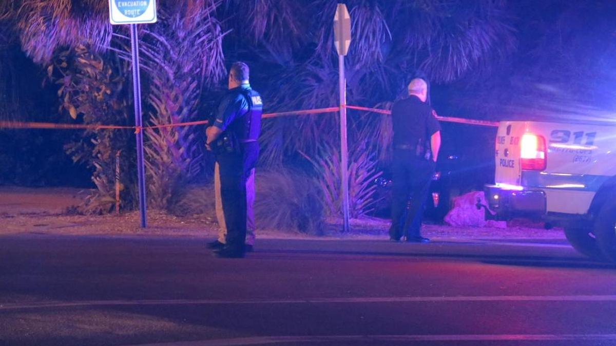 Holmes Beach Police Chief William Tokajer, left, speaks with another investigator at the scene of the shooting Saturday evening in Anna Maria.