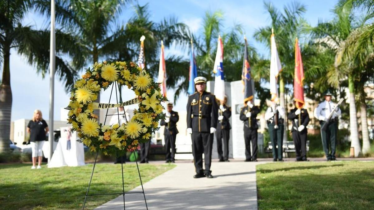A memorial wreath is placed before Cdr. Matthew Garcia and the Manatee County Honor Guard at the Tribute to Heroes memorial service event for 9/11 first responders at Riverwalk on Sept. 12, 2016.
