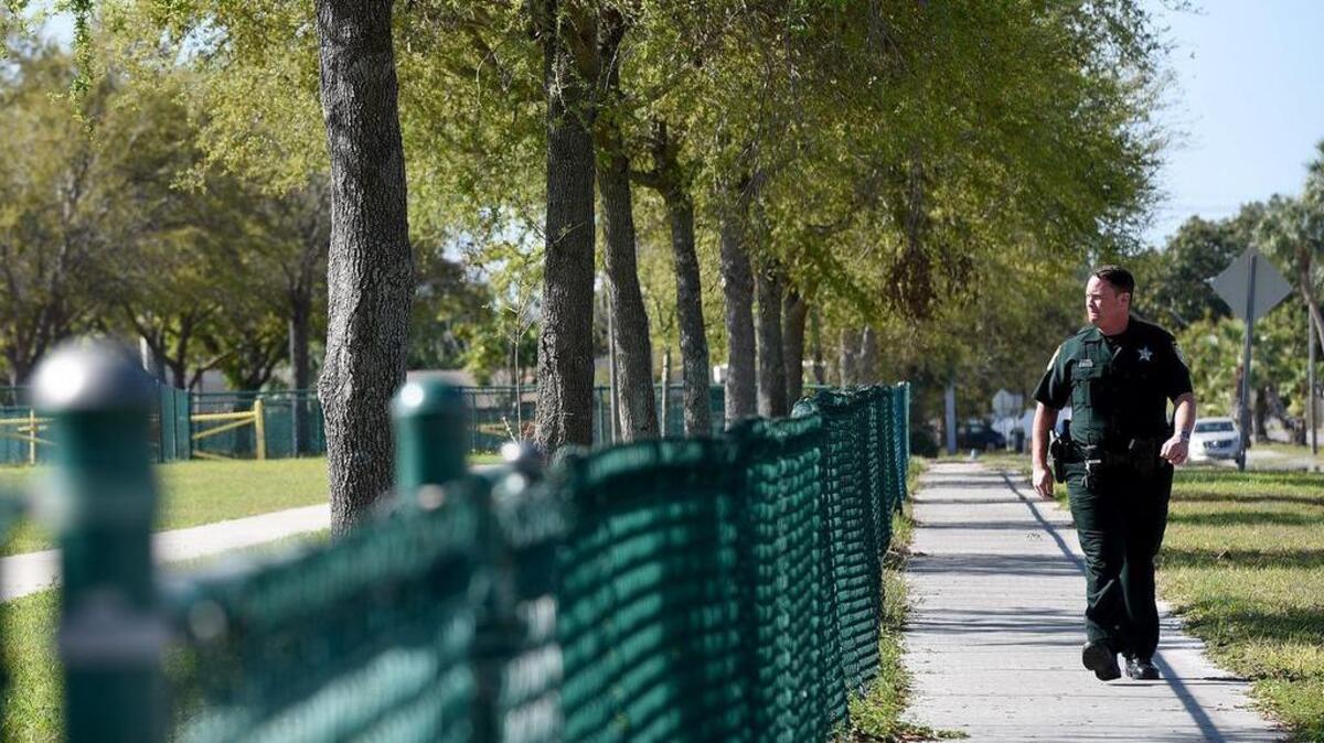 A Manatee County deputy walks the perimeter of Prine Elementary School as more school resource officers are deployed at schools across the country following the Valentine’s Day mass shooting at Marjory Stoneman Douglas High School that left 17 people dead.