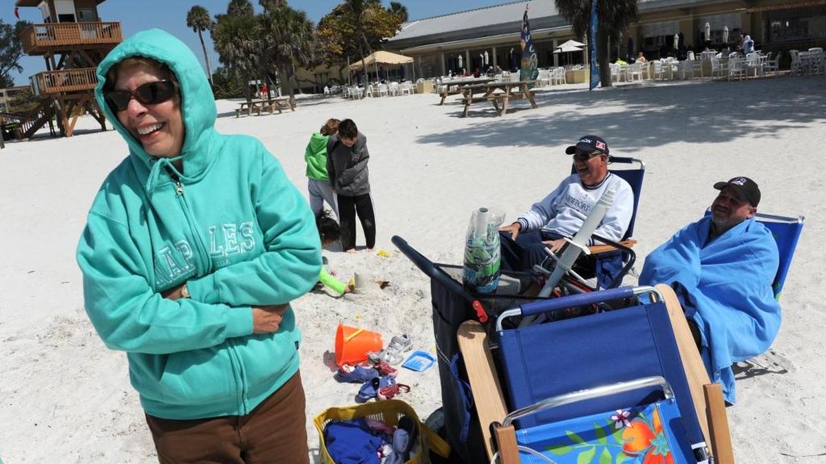 Tourist spend an unseasonably cold day at Manatee Public Beach.