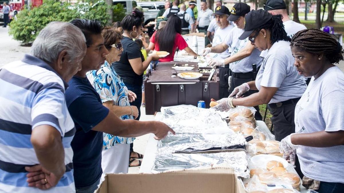 Locals line up for barbecue as the Manatee County Sheriff's Office hosts a community BBQ on Saturday afternoon at Pride Park in Bradenton.